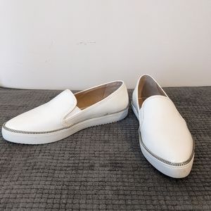 Vince Camuto white leather slip-ons. The sole is sneaker-like..